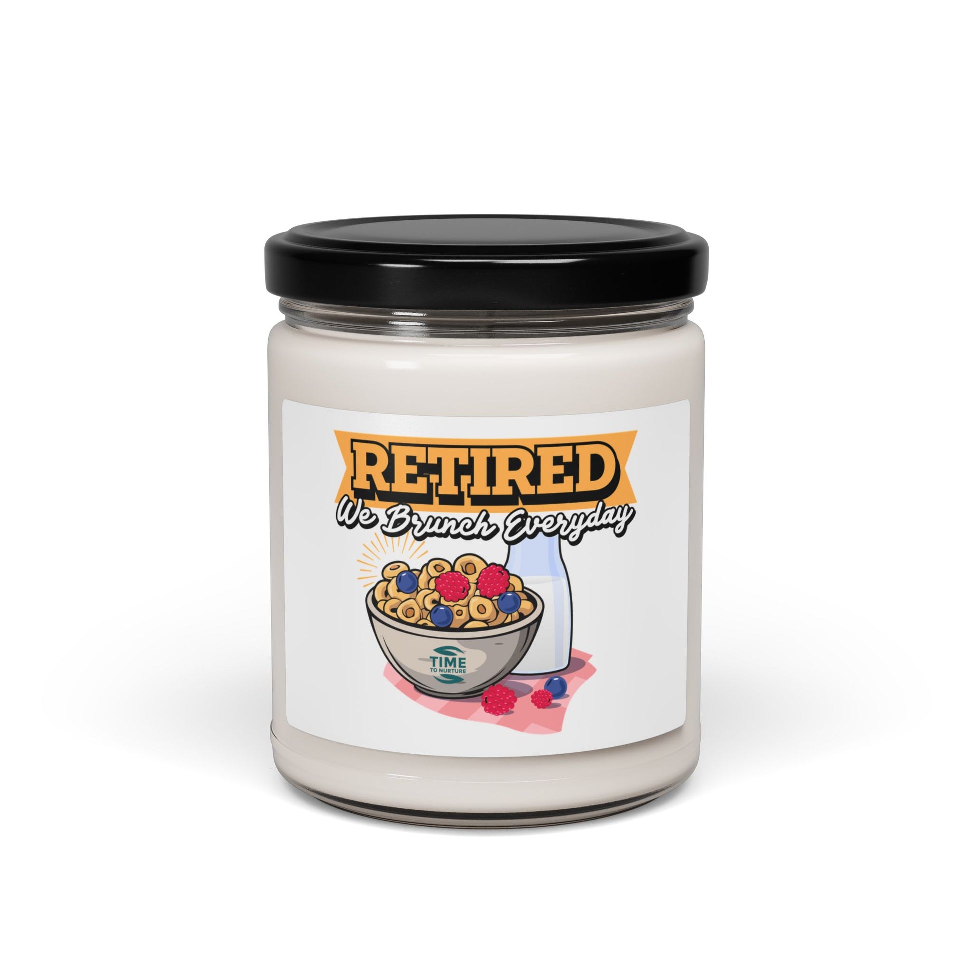 9oz amber jar candle with a cotton wick, labeled 'Retired, We Brunch Everyday.' The candle features a natural soy wax blend and cozy aromatic scents designed for relaxation and ambiance.2