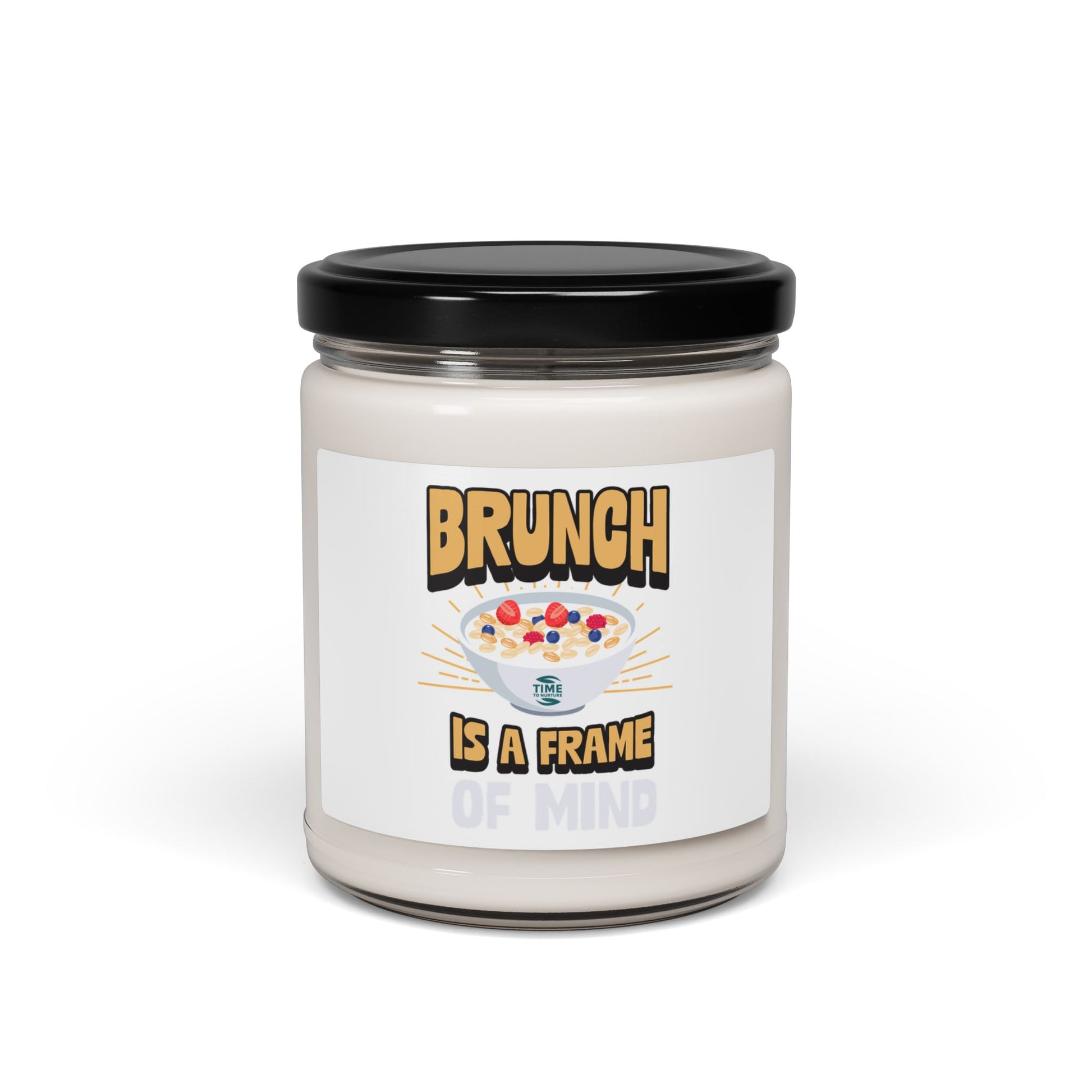 A "Brunch Is a Frame of Mind" scented soy candle in a stylish amber glass jar. The 9oz candle features natural soy wax, a cotton wick, and a long burn time, offering inviting aromatic scents for a cozy ambiance and relaxation.