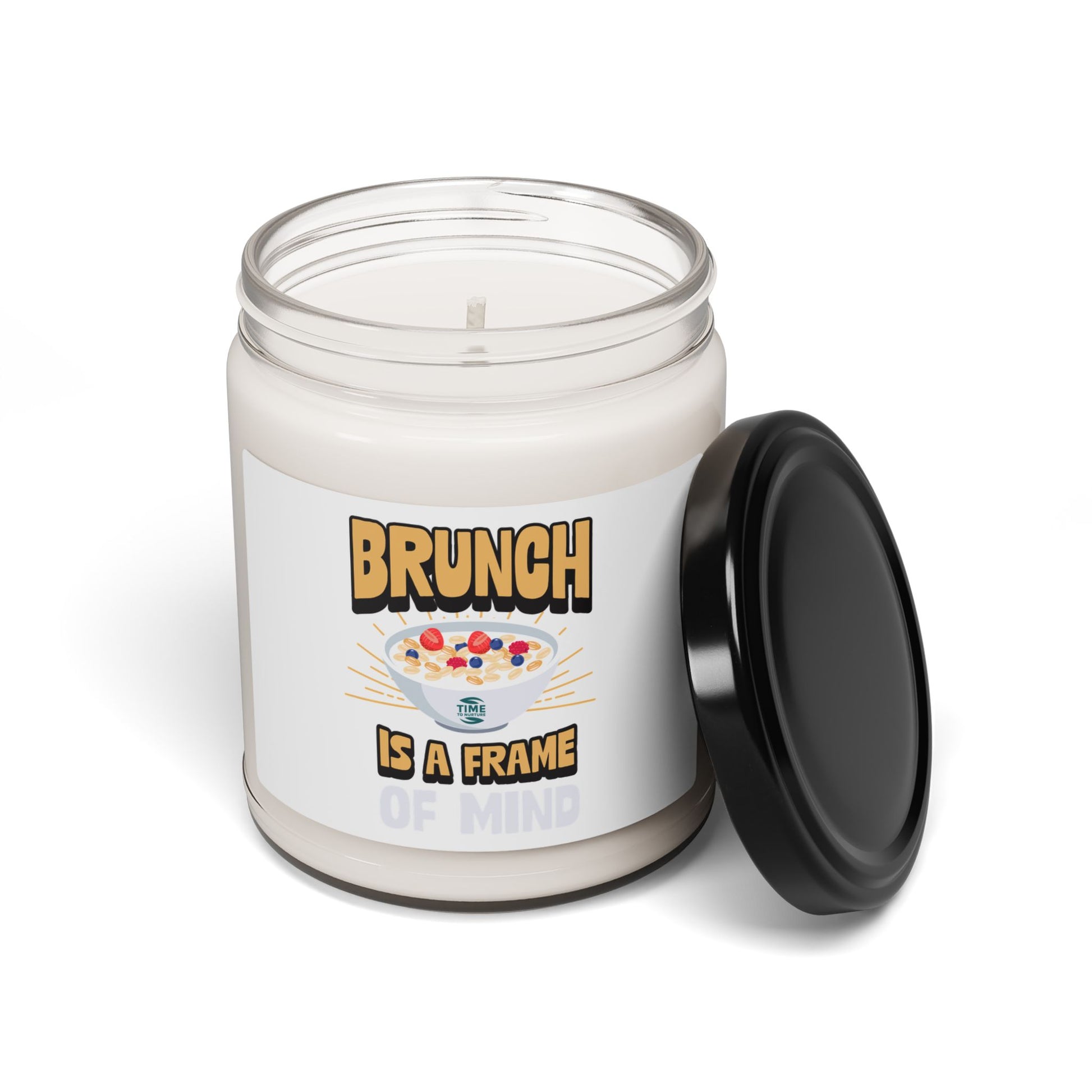 A "Brunch Is a Frame of Mind" scented soy candle in a stylish amber glass jar. The 9oz candle features natural soy wax, a cotton wick, and a long burn time, offering inviting aromatic scents for a cozy ambiance and relaxation.