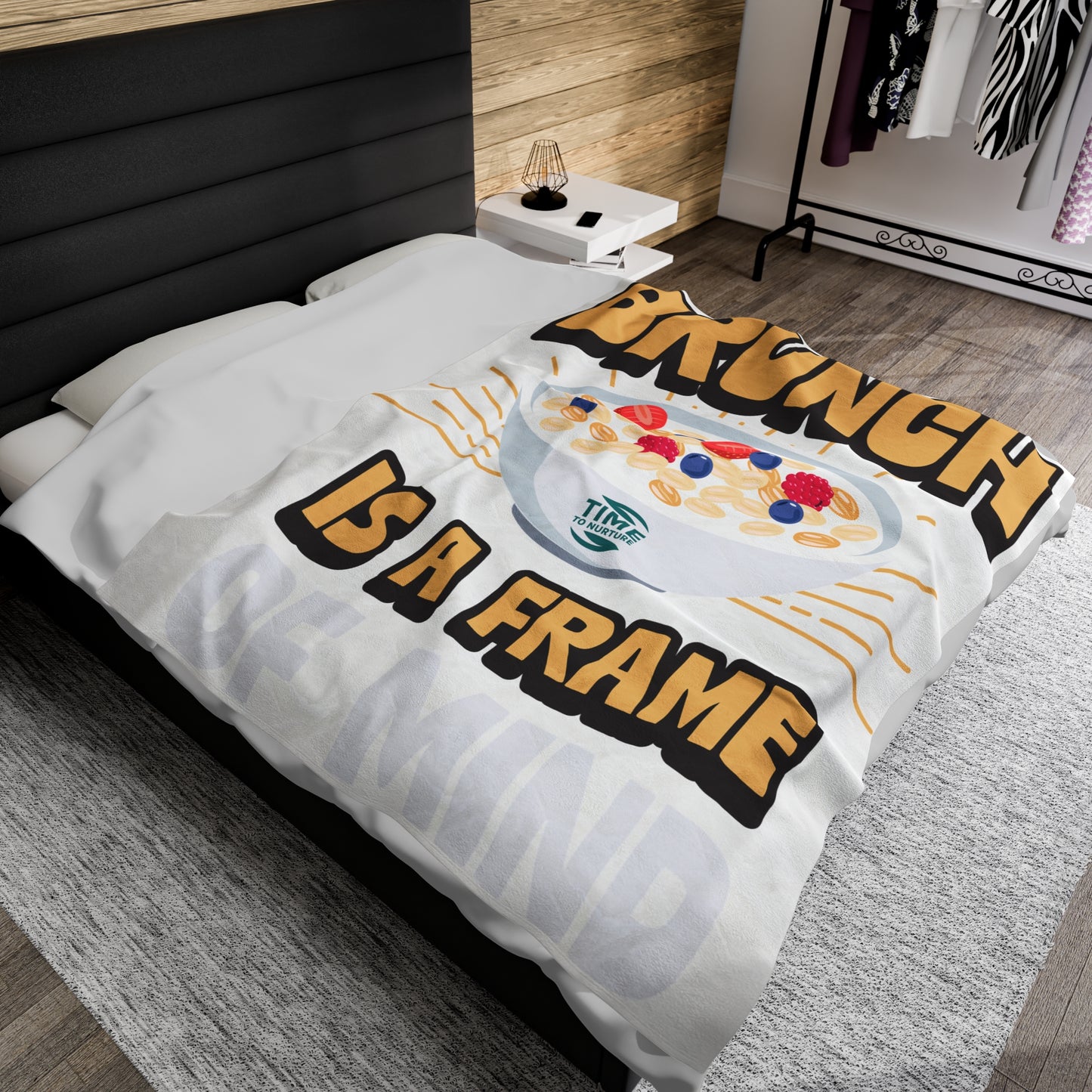 velveteen plush blanket with text "Brunch is a Frame of Mind" printed in elegant lettering, showcasing a cozy, soft texture ideal for lounging. Designed as home decor, it makes a thoughtful retirement gift, housewarming present, or stylish lounge throw.